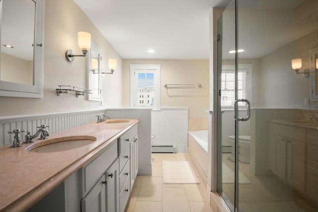 full bathroom with plus walk in shower, toilet, tile patterned flooring, a baseboard heating unit, and vanity