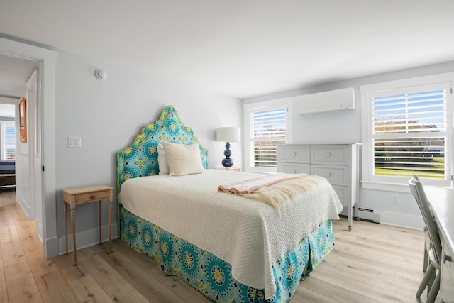 bedroom featuring baseboard heating, a wall unit AC, and light hardwood / wood-style floors