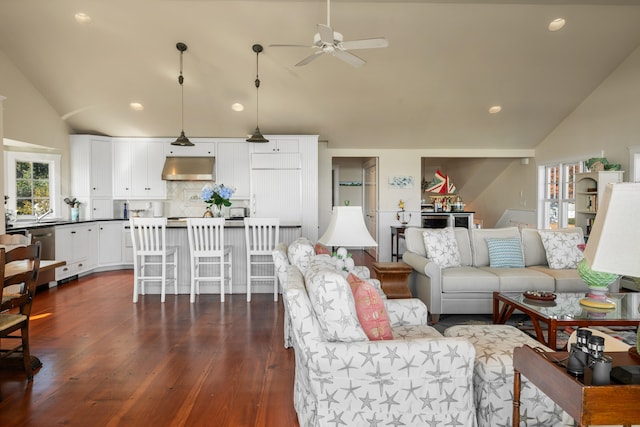 living room with dark wood-type flooring, ceiling fan, and lofted ceiling