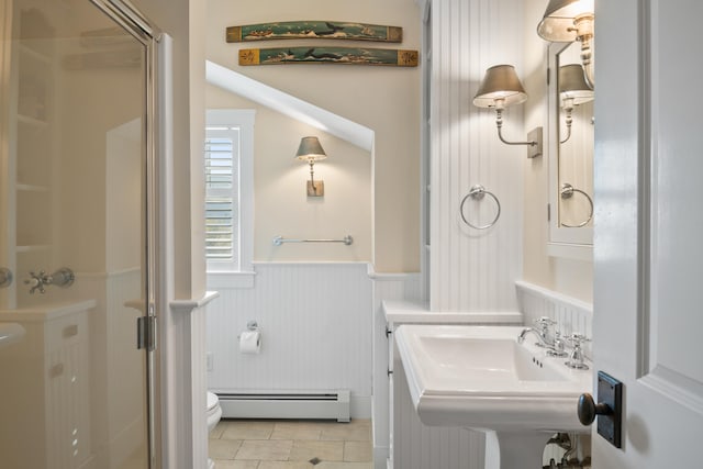 bathroom with tile patterned floors, toilet, a baseboard heating unit, sink, and an enclosed shower