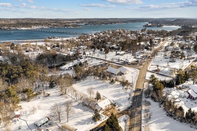 snowy aerial view featuring a water view