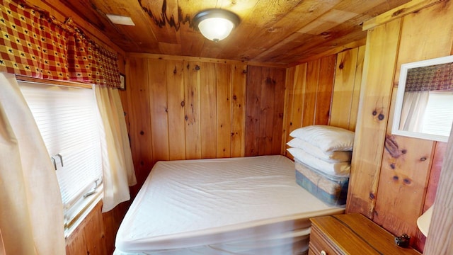 bedroom featuring wood walls and wood ceiling