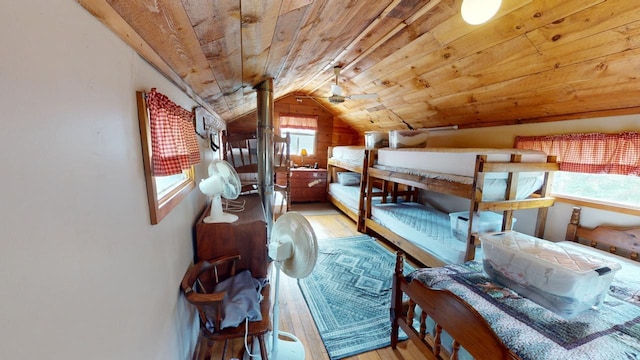 unfurnished bedroom with wood ceiling, light hardwood / wood-style floors, and lofted ceiling