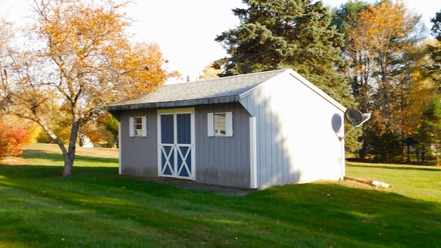 view of outbuilding featuring a yard