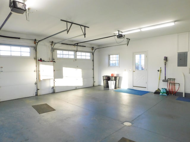 garage with a garage door opener and electric panel