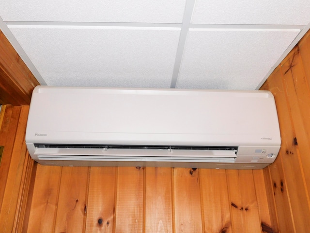 interior details featuring wood walls and a wall unit AC