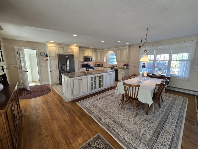 dining room with a baseboard radiator, sink, and light wood-type flooring