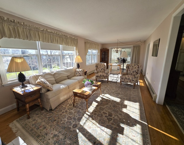 living room featuring dark hardwood / wood-style flooring, a chandelier, and a baseboard radiator