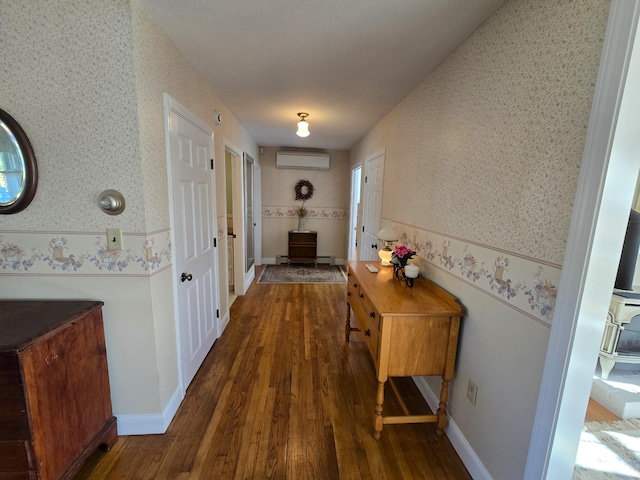 corridor with dark hardwood / wood-style flooring and an AC wall unit