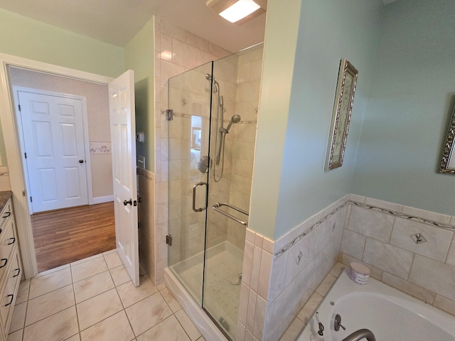 bathroom featuring vanity, plus walk in shower, and hardwood / wood-style flooring