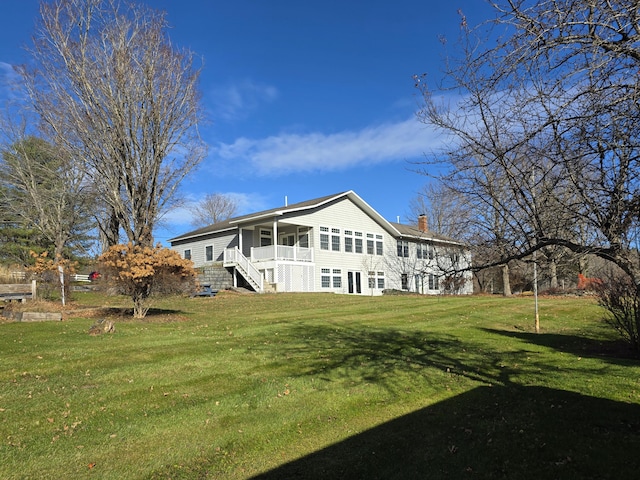 rear view of property with a lawn