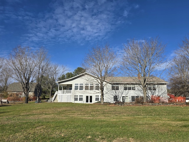 back of house featuring a lawn