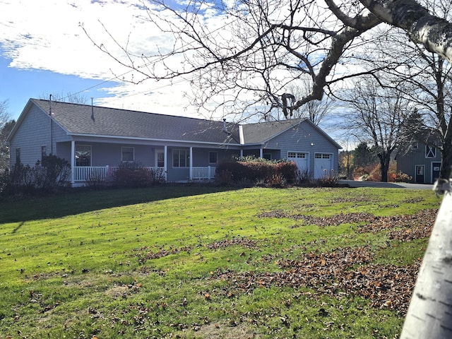 back of house with a garage and a yard