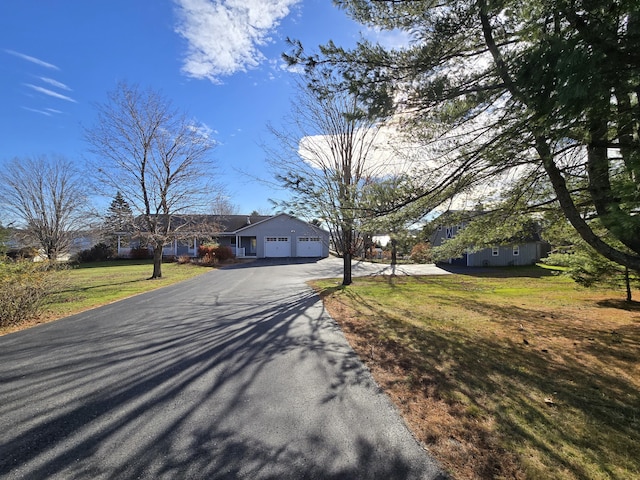 view of front of house featuring a front lawn and a garage