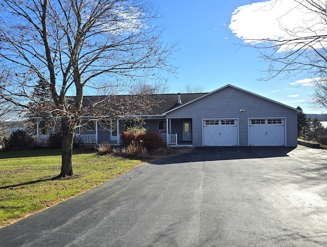 ranch-style house featuring a garage and a front yard