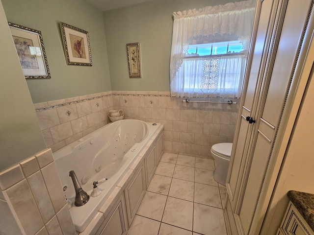 bathroom featuring a tub, tile patterned floors, toilet, and tile walls