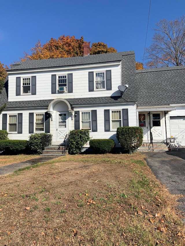 view of front property with cooling unit and a garage