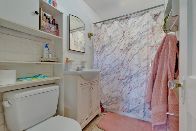 bathroom featuring toilet, tasteful backsplash, and vanity