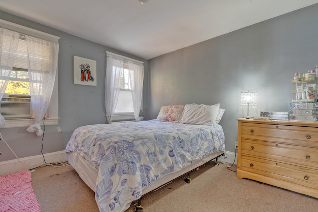 carpeted bedroom with cooling unit and multiple windows
