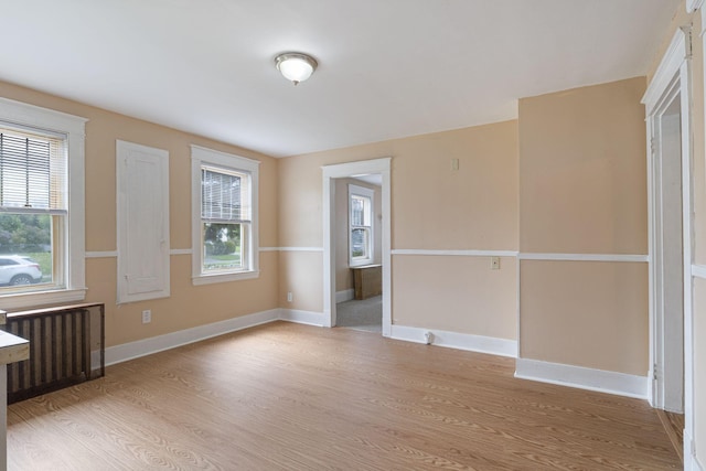19 Harding St, Biddeford, ME 04005 - unfurnished bedroom with light wood finished floors, radiator, and baseboards