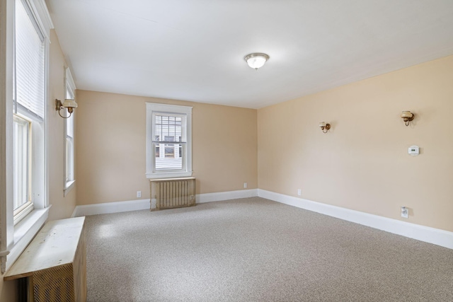 19 Harding St, Biddeford, ME 04005 - carpeted empty room with radiator heating unit and baseboards