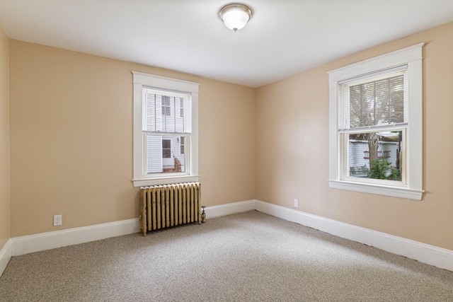 19 Harding St, Biddeford, ME 04005 - carpeted empty room with radiator heating unit and baseboards