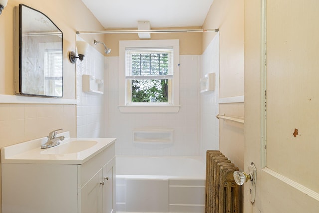 19 Harding St, Biddeford, ME 04005 - bathroom featuring radiator heating unit, tile walls, vanity, and bathing tub / shower combination