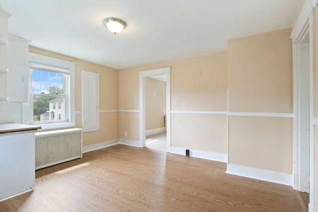 19 Harding St, Biddeford, ME 04005 - unfurnished dining area featuring radiator, light wood-type flooring, and baseboards