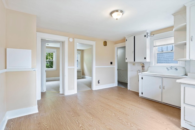 19 Harding St, Biddeford, ME 04005 - kitchen with light countertops, open shelves, and white cabinetry