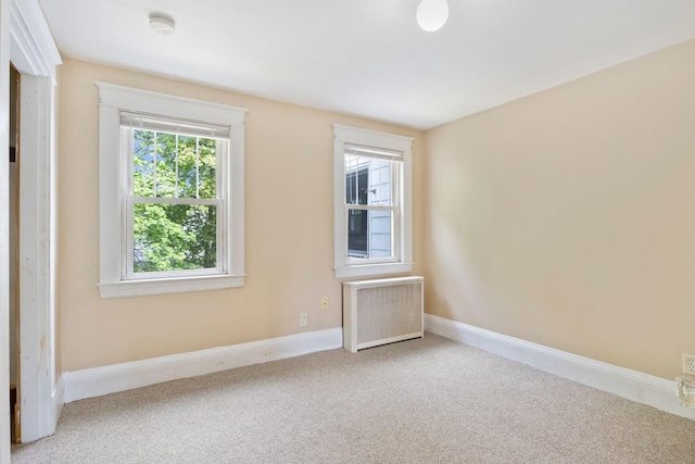 19 Harding St, Biddeford, ME 04005 - carpeted spare room with radiator heating unit and baseboards