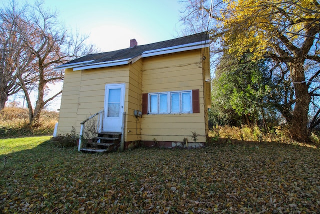 rear view of house with a lawn