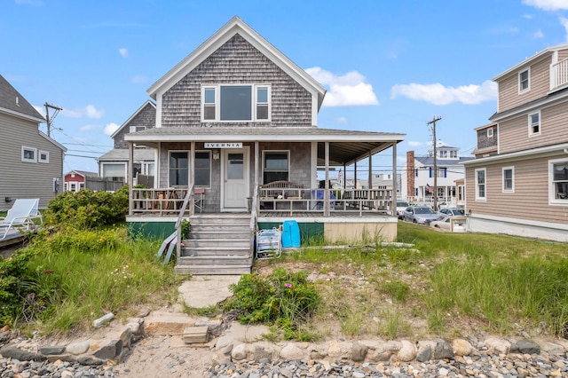 rear view of house featuring a porch