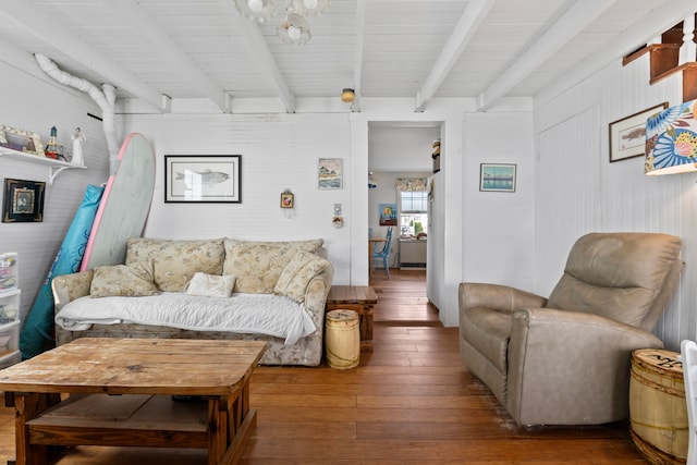 living room featuring beamed ceiling and hardwood / wood-style flooring