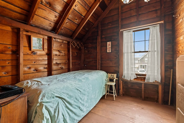 bedroom featuring vaulted ceiling with beams, wood ceiling, wooden walls, and light wood-type flooring