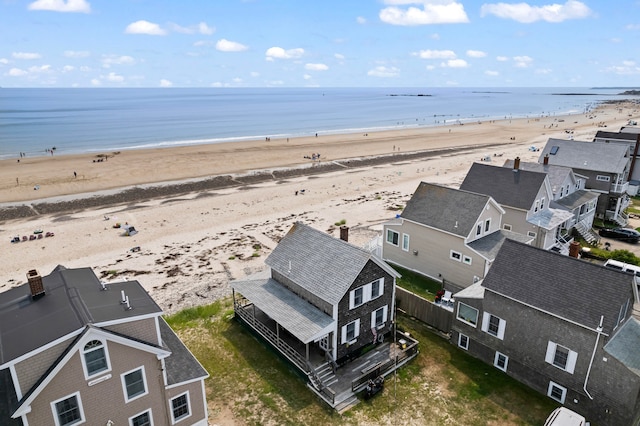 birds eye view of property with a view of the beach and a water view