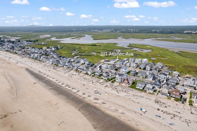 drone / aerial view featuring a water view and a view of the beach