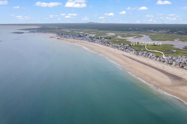 aerial view with a water view and a beach view