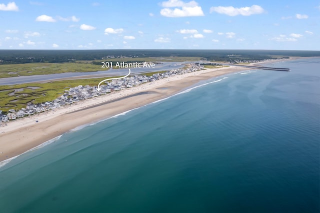 birds eye view of property with a water view and a view of the beach