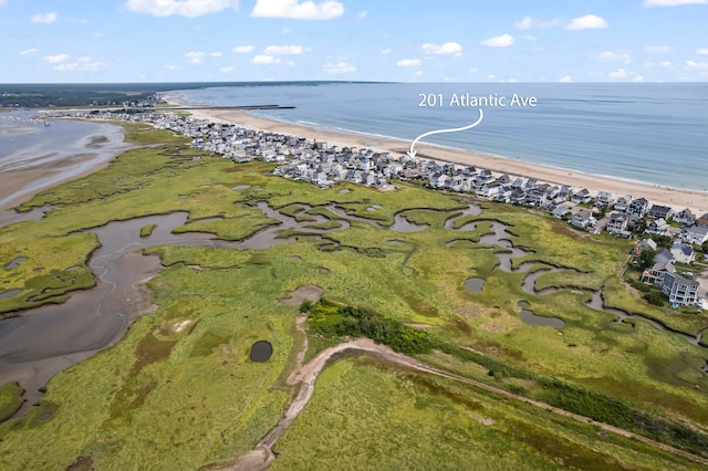 birds eye view of property featuring a water view and a view of the beach