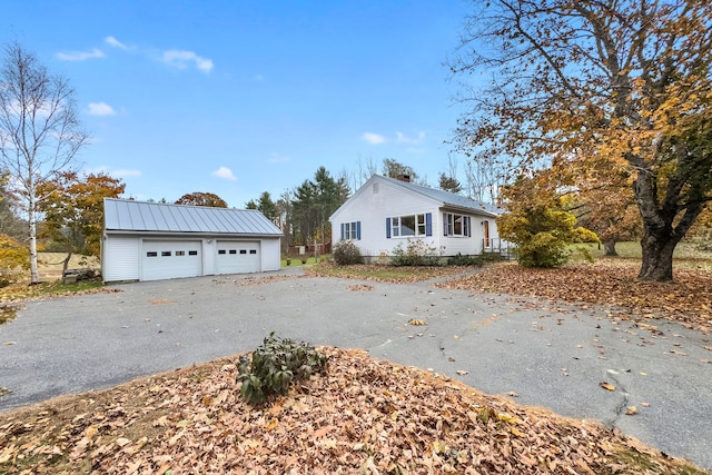 view of front facade featuring a garage and an outdoor structure