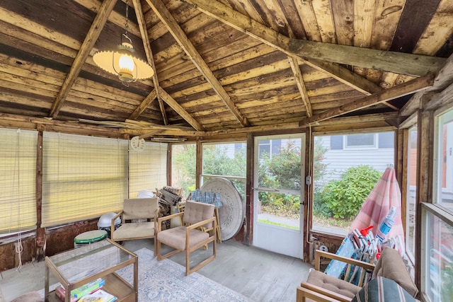 unfurnished sunroom featuring vaulted ceiling with beams and wood ceiling