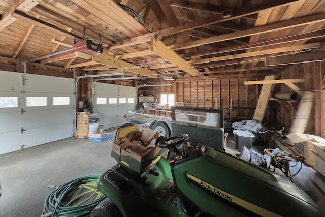 garage featuring wood ceiling and a garage door opener