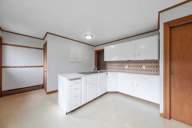 kitchen featuring sink, kitchen peninsula, tasteful backsplash, white cabinets, and a baseboard radiator