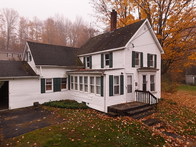 rear view of property with a sunroom