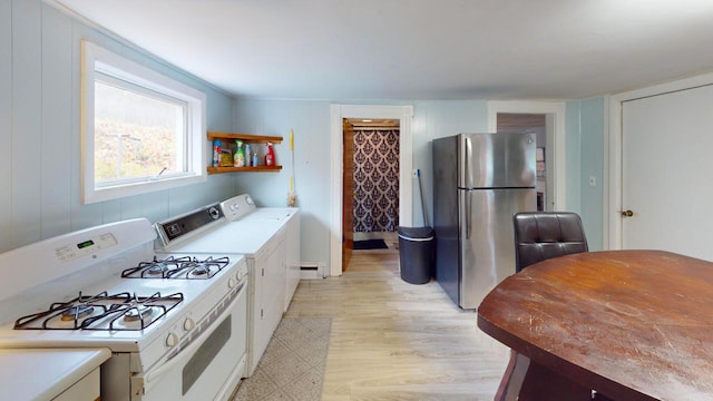 kitchen with a baseboard heating unit, gas range gas stove, stainless steel fridge, light hardwood / wood-style floors, and white cabinets