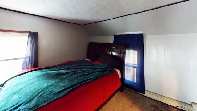 carpeted bedroom with a textured ceiling and vaulted ceiling