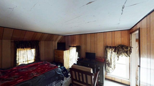 bedroom featuring wood walls