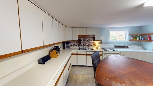 kitchen featuring light hardwood / wood-style flooring, white cabinetry, tasteful backsplash, and sink