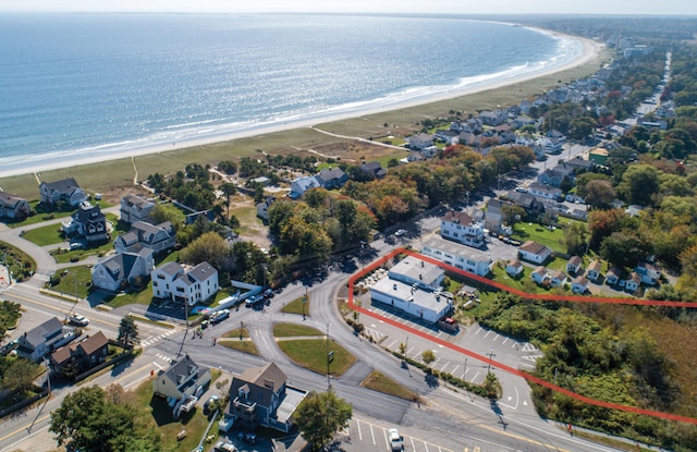 bird's eye view with a water view and a beach view