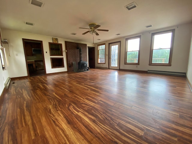 unfurnished living room with a wood stove, a baseboard radiator, and dark hardwood / wood-style flooring